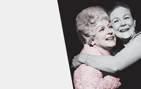 Mary Kay Ash embraces a member of the Mary Kay independent sales force in a warm hug as both women smile.
