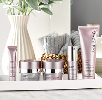 A picture of TimeWise Repair® eye cream in a pink tube, night cream in a silver and pink jar, day cream with SPF sunscreen in a pink jar, advanced lifting serum in a pink and silver bottle and foaming cleanser in a pink tube on a countertop