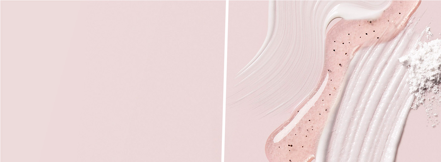 Artistic smears of Mary Kay® physical and chemical exfoliants on light pink background 